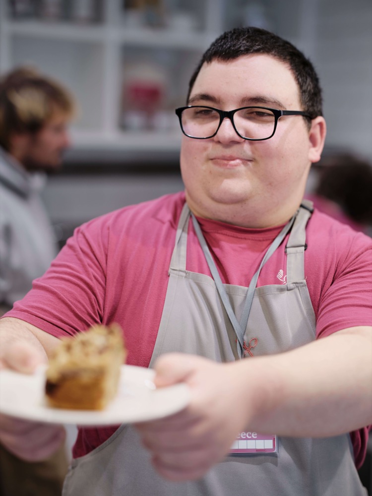 Man serving a customer a cake